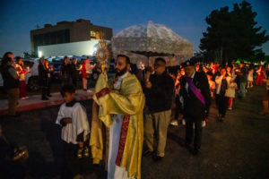 Transitional deacon Alejandro Reynaga carries the Blessed Sacrament during the Carmelite Sisters of the Most Sacred Heart of Los Angeles' special Mass and candlelight procession in response to the Dodgers' decision to honor the Sisters of Perpetual Indulgence on Friday, June 16. (John Rueda/ADLA)