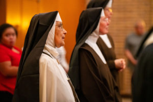 The Carmelite Sisters of the Most Sacred Heart of Los Angeles sing during a special Mass and candlelight procession in response to the Dodgers' decision to honor the Sisters of Perpetual Indulgence on Friday, June 16. (John Rueda/ADLA)