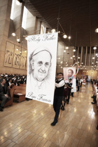 Students process in with portraits of Pope Francis and saints during the annual Missionary Childhood Association Youth Mass on Oct. 17 at Cathedral of Our Lady of the Angels. (Victor Alemán)