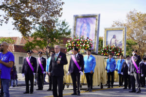 The Knights of Columbus and students from Bishop Mora Salesian High School’s Letterman Society help process with the pilgrimage images during the 92nd procession and Mass honoring Our Lady of Guadalupe and St. Juan Diego on Dec. 3. (Sarah Yaklic)