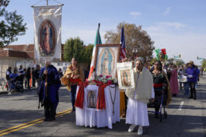 Participants walk with decorated floats during the 92nd Procession and Mass honoring Our Lady of Guadalupe and St. Juan Diego at East LA College Stadium on Dec. 3. (Sarah Yaklic)