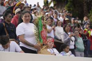 A woman holds a statue of Our Lady during the 92nd Procession and Mass honoring Our Lady of Guadalupe and St. Juan Diego at East LA College Stadium on Dec. 3. (Sarah Yaklic)