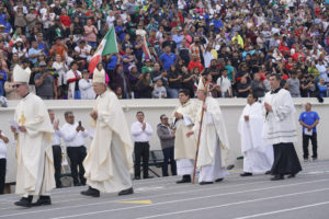 Los Angeles Archbishop José H. Gomez, Cardinal Roger M. Mahony and other priests process in during the 92nd Procession and Mass honoring Our Lady of Guadalupe and St. Juan Diego at East LA College Stadium on Dec. 3. (Sarah Yaklic)