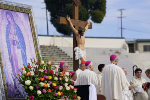 The pilgrim image of Our Lady of Guadalupe is displayed near the cross of Jesus during the 92nd Procession and Mass honoring Our Lady of Guadalupe and St. Juan Diego at East LA College Stadium on Dec. 3. (Sarah Yaklic)