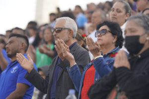 Participants pray in the stands during the 92nd Procession and Mass honoring Our Lady of Guadalupe and St. Juan Diego at East LA College Stadium on Dec. 3. (Sarah Yaklic)