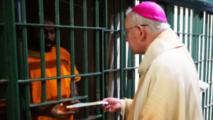 Los Angeles Archbishop José H. Gomez handed out copies of “The Twelve Steps and the Sacraments” by Scott Weeman to inmates at Men’s Central Jail in Los Angeles after celebrating Christmas Mass the morning of Dec. 25. Archbishop Gomez’s visits to the jail have become a Christmas Day tradition. (Victor Alemán)