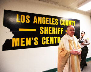 Los Angeles Archbishop José H. Gomez prepares to celebrate Christmas Mass on Dec. 25 at Men’s Central Jail in Los Angeles.  (Victor Alemán)