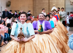 A parade of colorful parishioners hold up their statues during the Feast of Santo Niño Mass at the Cathedral of Our Lady of the Angels on Jan. 21. (Victor Alemán)