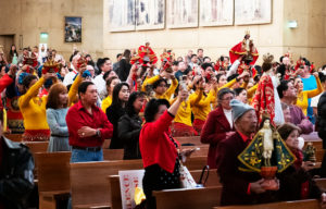 Churchgoers at the Feast of Santo Niño Mass hold up their statues to be blessed during the event at the Cathedral of Our Lady of the Angels on Jan. 21. (Victor Alemán)