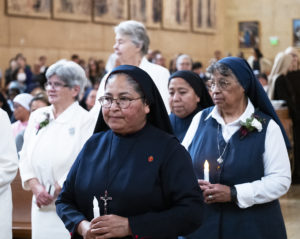 Several local women religious who are celebrating jubilee anniversaries this year hold candles during the annual Jubilarian Mass on Jan. 28 at the Cathedral of Our Lady of the Angels. (Victor Alemán)