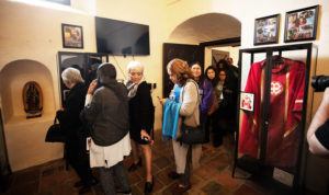 Attendees browse the memorial exhibit following the Feb. 24 memorial Mass for Auxiliary Bishop David O'Connell at Mission San Gabriel to mark the one-year anniversary of his death. (Victor Alemán)