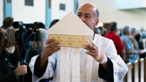 A miter belonging to late Auxiliary Bishop David O’Connell is brought forward at the start of a Feb. 24 memorial Mass at Mission San Gabriel marking a year since his death. (Victor Alemán)