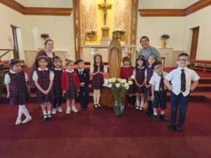 The kindergarten class and teachers Mrs. Romero and Mrs. Hneiti at Saints Felicitas and Perpetua School in San Marino pose with the Mary statue during a May Crowning event.  (Noreen Maricich)