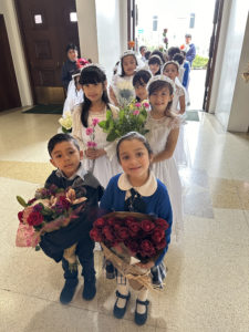 Students at St. John Chrysostom School in Inglewood line up to offer flowers to Mary during a May Crowning event on (St. John Chrysostom Church)