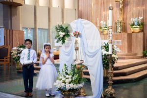 Yeshua Portillo and Katherine Xu pose next to the crowned Mary statue during a May Crowning event on May 5 at St. Therese Church in Alhambra. (Victor Arreguin)