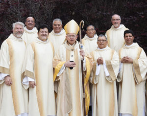 The eight deacons pose with Archbishop José H. Gomez following their ordination Mass at the Cathedral of Our Lady of the Angels on June 8. (Victor Alemán)