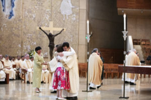 Alejandro Villanueva receives a hug from his wife, Elisa, during the permanent deacon ordination on June 8. (Victor Alemán)