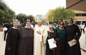 Deacon Antonio Alcocer and his wife, Alicia, pose with some religious sisters following his ordination Mass. (Victor Alemán)