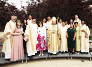 Archbishop José H. Gomez poses with the newly ordained deacons and their wives: Antonio and Alicia Alcocer, Pedro and Consuelo Cardenas, Frank and Mary Faria, Lloyd “Rex” and Karen Owens, Gary and Shelly Smith, Renee and Cynthia Sosa, Hieu and Thu Tran, and Alejandro and Elisa Villanueva. (Victor Alemán)