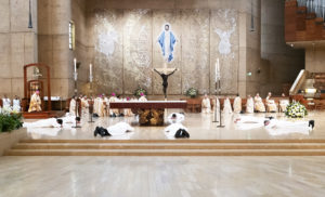 The eight men prostrate themselves on the altar during the permanent deacon ordination Mass at the Cathedral of Our Lady of the Angels on June 8. (Victor Alemán)