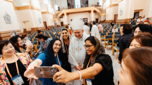 Archbishop Jose H. Gomez poses for a selfie after a special Mass for LA pilgrims at the Sts. Peter & Paul Cathedral in Indianapolis July 19 during the National Eucharistic Congress. (Archdiocese of Los Angeles)