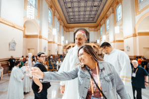 Los Angeles Auxiliary Bishop Albert Bahhuth takes a photo with an LA Catholic following a special Mass for LA pilgrims at the Sts. Peter & Paul Cathedral in Indianapolis July 19 during the National Eucharistic Congress. (Archdiocese of Los Angeles)