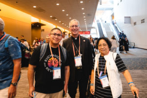 Los Angeles Auxiliary Bishop Marc Trudeau poses with LA Catholics Dom and Charito Salas during the National Eucharistic Congress in Indianapolis. (Archdiocese of Los Angeles)