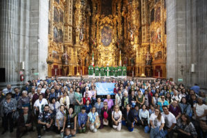 Archbishop José H. Gomez and other priests pose with the hundreds of pilgrims after a Mass at the Metropolitan Cathedral in Mexico City on July 5. (Victor Alemán)