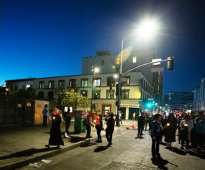 People stop to pray and assist the homeless on Skid Row during a Eucharistic procession on the evening of July 27 put on by the Archdiocese of Los Angeles’ Office for Vocations and the Friars and Sisters of the Poor of Jesus Christ LA. (Victor Alemán)