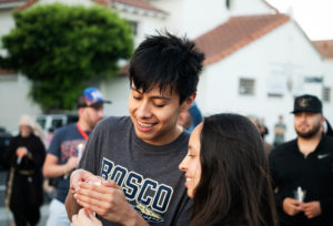 Two people light candles as more than 300 priests, seminarians, and lay Catholics joined the archdiocese's Office of Vocations and the Friars and Sisters of the Poor of Jesus Christ LA for a Eucharistic Procession through downtown LA’s Skid Row on Saturday, July 27. (Victor Alemán)