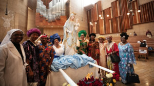 Local Nigerian Catholics with the Statue of Our Lady of the Angels featured at the 20th anniversary “One Mother, Many Peoples” Mass at the Cathedral of Our Lady of the Angels on Sept. 7. The multilingual event celebrates the many ethnic and cultural groups in the archdiocese. (Victor Alemán)