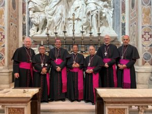 Father Reynaldo Bersabal, the new auxiliary bishop for the Diocese of Sacramento, and Father Michael Pham and Father Felipe Pulido, new auxiliary bishops for the Diocese of San Diego, pose with LA’s four newest auxiliary bishops in front of the tomb of St. Pope Leo the Great inside St. Peter’s Basilica. (Submitted photo)