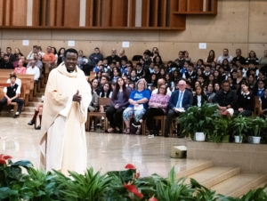 Father Frederick Byaruhanga, a priest originally from the Diocese of Kabale in Uganda and now a chaplain for the VA Greater Los Angeles, addresses the crowd during his homily for the annual Missionary Childhood Association Youth Appreciation Mass on Oct. 16. (Victor Alemán) 