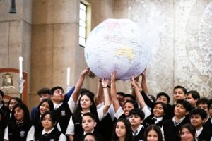 Students hold up an inflatable globe after the annual Missionary Childhood Association Youth Appreciation Mass on Oct. 16. (Victor Alemán)