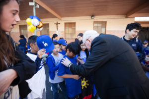 Archbishop José H. Gomez signs Dodgers hats and shirts during an event at Incarnation School in Glendale on Nov. 8 to celebrate funds raised for Catholic Education Foundation of Los Angeles thanks to the Dodgers winning the World Series.(Victor Alemán)