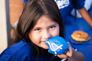 Students received Dodgers-themed donuts from Randy's Donuts during an event at Incarnation School in Glendale on Nov. 8 to celebrate funds raised for Catholic Education Foundation of Los Angeles thanks to the Dodgers winning the World Series.(Victor Alemán)