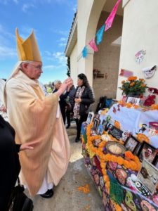 Archbishop José H. Gomez blesses altars at a Día de los Muertos celebration at Santa Clara Cemetery in Oxnard on Nov. 2. (Maria Hurtado)