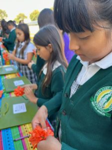 Nearly 200 students from nearby Catholic schools made crafts and built altars at Calvary Cemetery in East LA on Oct. 24 to learn about the meaning of Día de los Muertos. (Maria Hurtado)