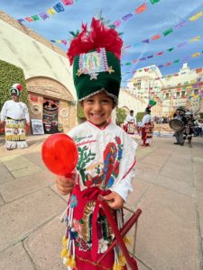 A young dancer prepares to perform at a Día de los Muertos celebration at Calvary Cemetery in East LA on Oct. 26.  (Maria Hurtado)