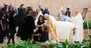 Los Angeles Archbishop José H. Gomez offers blessings to Fernando Valenzuela's family during his funeral Mass on Nov. 6 at the Cathedral of Our Lady of the Angels. (Victor Alemán)