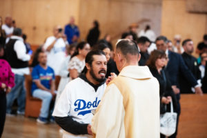 A Dodgers fan receives Communion during Fernando Valenzuela's funeral Mass on Nov. 6 at the Cathedral of Our Lady of the Angels. (Victor Alemán)