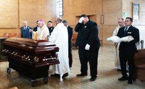 Los Angeles Archbishop José H. Gomez sprinkles holy water over the casket of Dodgers legend Fernando Valenzuela during his funeral Mass on Nov. 6 at the Cathedral of Our Lady of the Angels. (Victor Alemán)