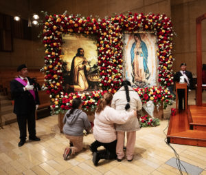 Attendees venerate in front of the pilgrim images of Our Lady of Guadalupe and St. Juan Diego. (Victor Alemán)