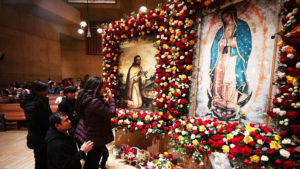 Attendees venerate in front of the pilgrim images of Our Lady of Guadalupe and St. Juan Diego at the Las Mañanitas event celebrating Our Lady of Guadalupe at the Cathedral of Our Lady of the Angels in the late-night hours of Dec. 11. (Victor Alemán)