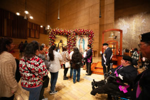 Attendees venerate in front of the pilgrim images of Our Lady of Guadalupe and St. Juan Diego at the Las Mañanitas event celebrating Our Lady of Guadalupe at the Cathedral of Our Lady of the Angels in the late-night hours of Dec. 11. (Victor Alemán)