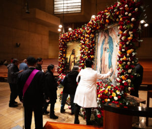 Attendees venerate in front of the pilgrim images of Our Lady of Guadalupe and St. Juan Diego at the Las Mañanitas event celebrating Our Lady of Guadalupe at the Cathedral of Our Lady of the Angels in the late-night hours of Dec. 11. (Victor Alemán)