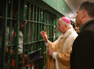 Archbishop José H. Gomez blesses inmates at LA Men's Central Jail during his annual visit and Mass on Christmas Day. (Victor Alemán)