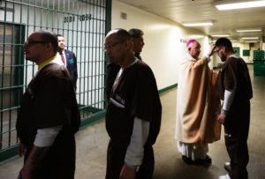 Archbishop José H. Gomez shakes hands and blesses inmates at LA Men's Central Jail following Mass on Christmas Day. (Victor Alemán)