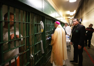 Archbishop José H. Gomez blesses inmates at LA Men's Central Jail during his annual visit on Christmas Day. (Victor Alemán)