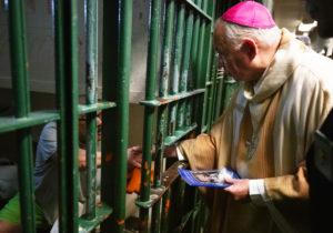 Archbishop José H. Gomez shakes hands and blesses inmates at LA Men's Central Jail during his annual visit on Christmas Day. (Victor Alemán)